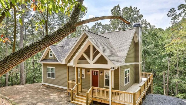 A two-story cabin with a front porch, a chimney, and a deck. - Dream Ridge | Ellijay, GA (Ellijay)