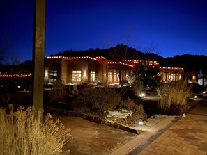 A building with a stone facade, multiple windows, and a well-lit entrance. - Casita de Paz en La Madera (La Madera)