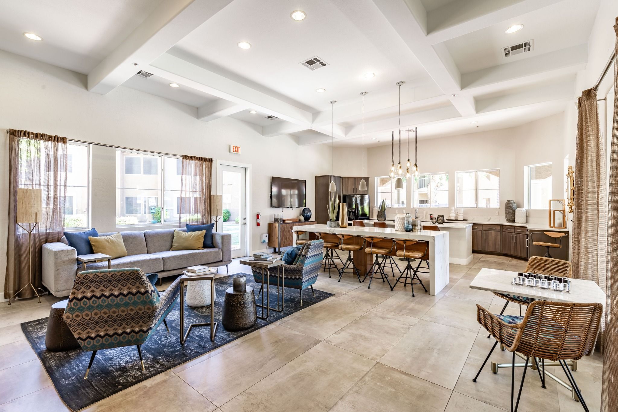 A spacious living area with a sofa, coffee table, and dining table with chairs.