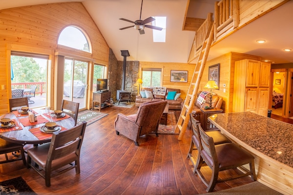 The great room has endless windows and many areas for everyone to relax and enjoy.