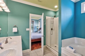 A bathroom with a shower, a sink, and a bathtub.
