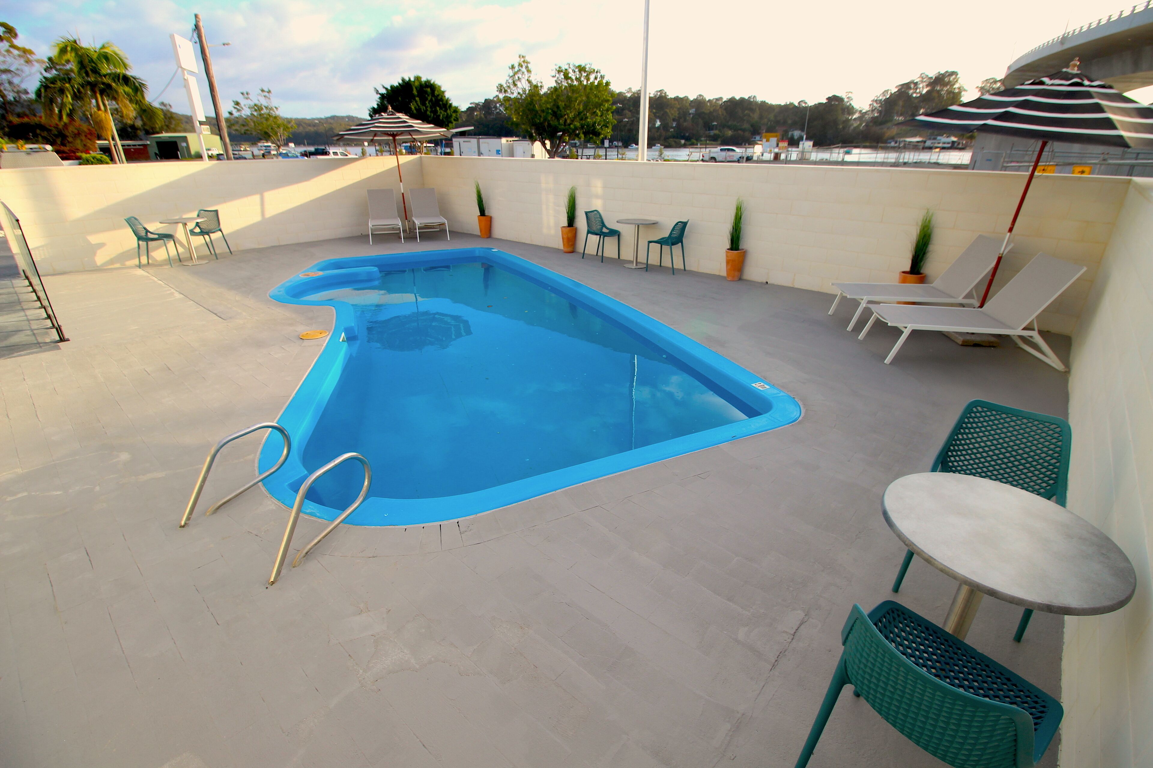 outdoor pool, open 9:00 am to 6:00 pm, pool umbrellas, pool loungers
