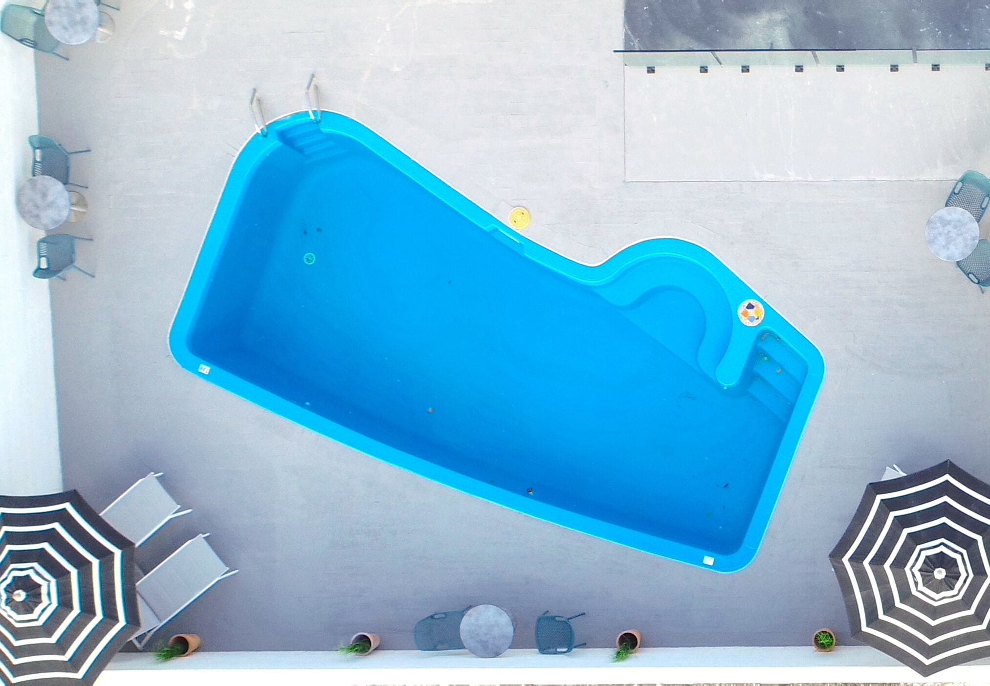 outdoor pool, open 9:00 am to 6:00 pm, pool umbrellas, pool loungers