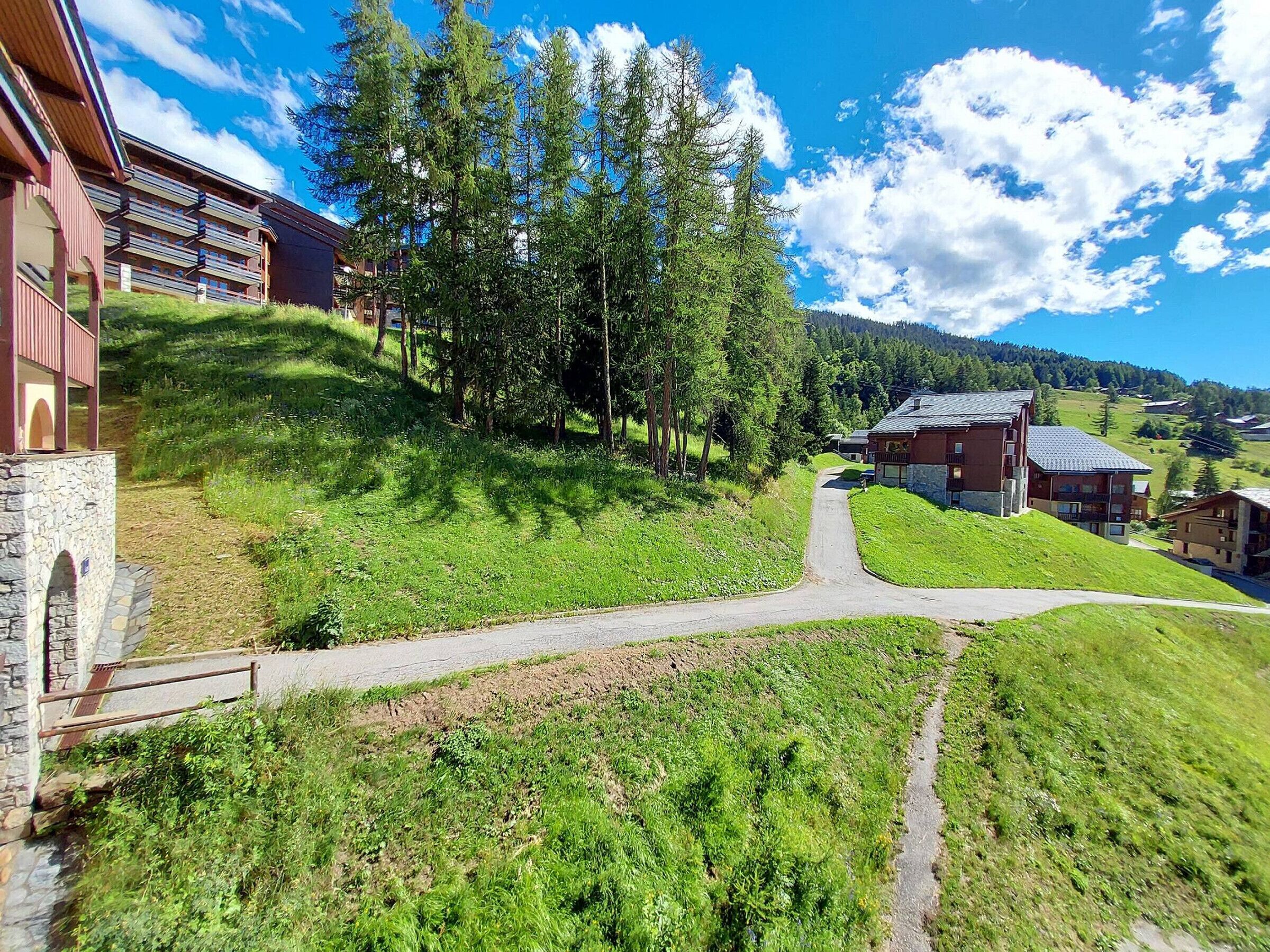 A hillside hotel with a stone pathway leading to the entrance.
