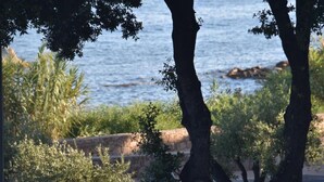 A coastal view with trees and a stone wall. - BRILOC Apartment (48 m² - 48 sq ft - ) (Ajaccio)