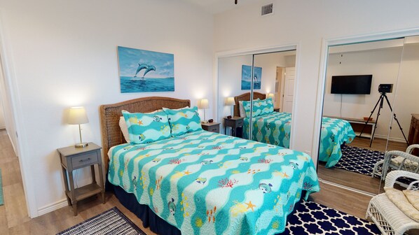 A bedroom with a bed, nightstands, a mirror, a TV, and a camera on a tripod. - Walk to Sandfest, Shared Pools, Boardwalk to Beach (Port Aransas)