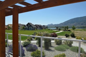 A residential area with houses, a clear sky, and a mountainous backdrop.