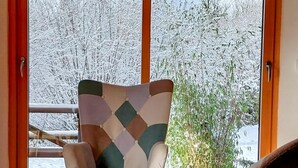 A cozy room with a large window, a chair, and a table. - Domaine Taureau, Morvan Regional Nature Park (Saint-Brisson)