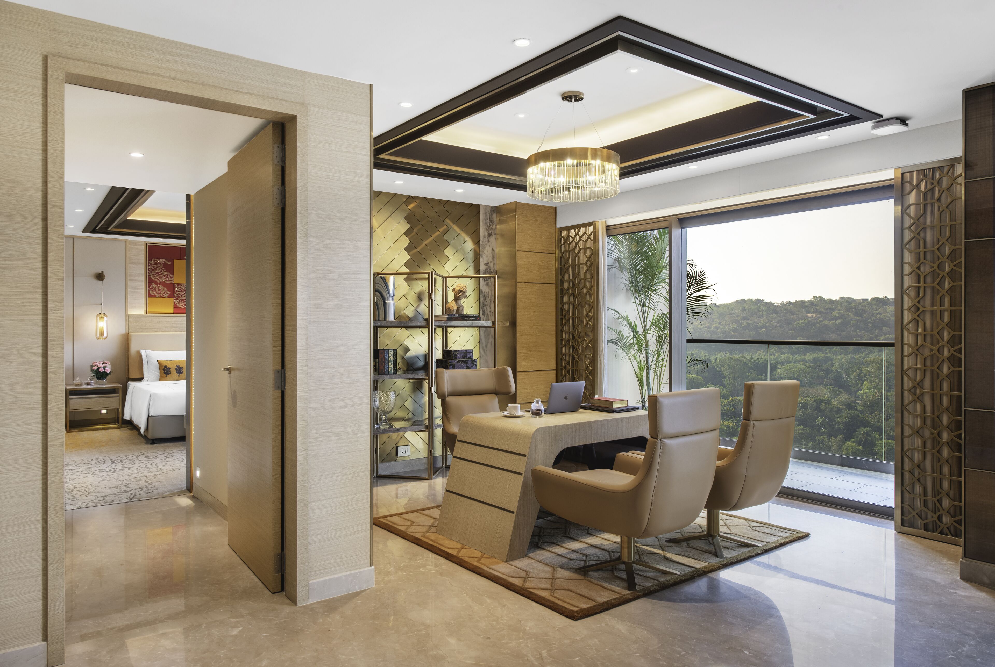 A modern interior with a dining area, a large window with a view, and a chandelier.