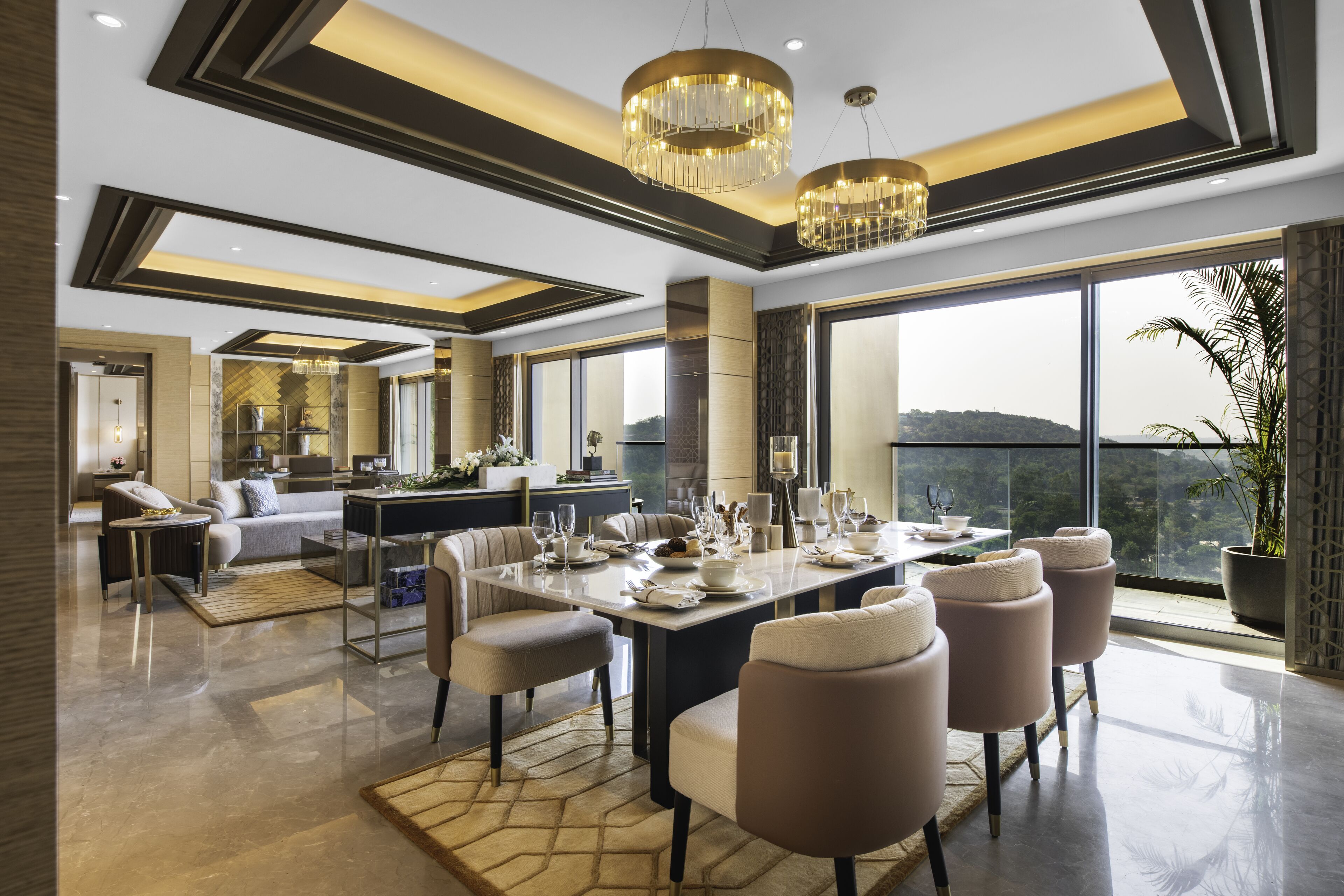 A modern dining area with a large table set for a meal, surrounded by comfortable seating.
