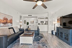 A modern living room with a sofa, coffee table, and a ceiling fan. - Tastefully Decorated, Perfect Scottsdale Location condo w/ Pool, Spa, Gym! (Scottsdale)