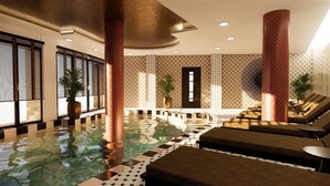Un área de spa con piscina, sillones reclinables y una mesa de recepción.