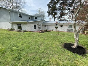 Stunning two-story home with a beautifully manicured lawn and a charming front entrance.