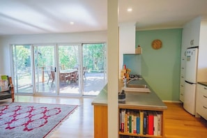 A modern kitchen with a built-in oven, a sink, and a clock on the wall. - 150  Steps to Beach with EV Charging (Apollo Bay)