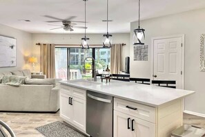 A modern kitchen with a central island, white cabinetry, and pendant lighting. - Pet Friendly Villa w/ Pool, Near Beach Hilton Head (Hilton Head Island)