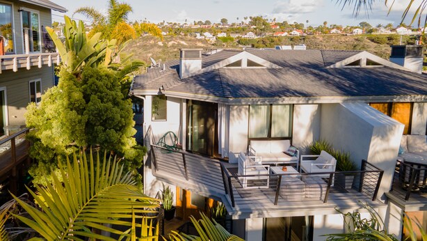 A modern house with a balcony, outdoor seating, and a view of a residential area. - Walk to the Beach/Rooftop Deck with Views/7 beds- 2 Kings/ A/C (Encinitas)
