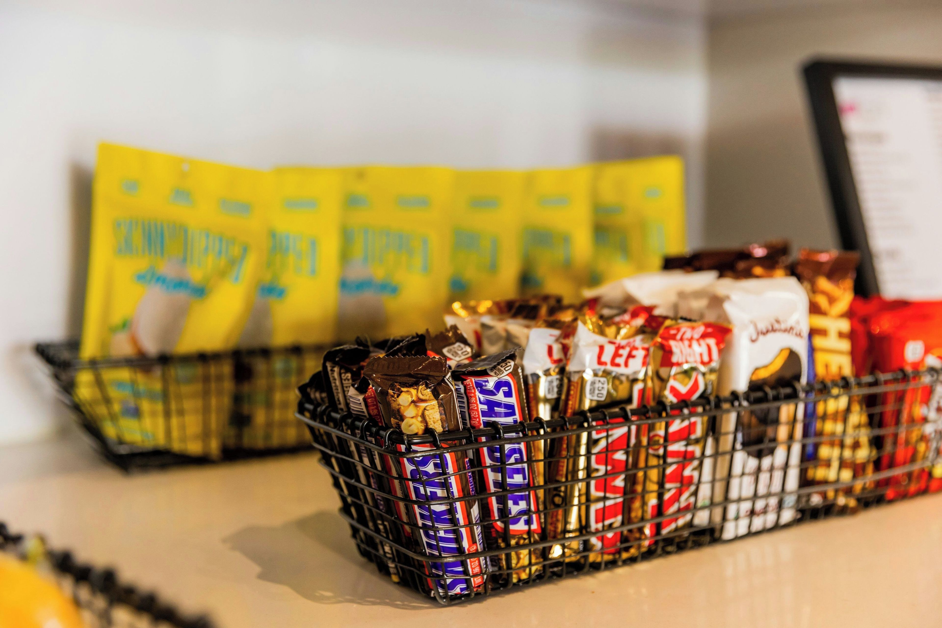 A basket filled with various chocolate bars and snacks.