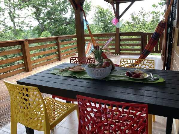 Enjoy a romantic meal for two in this serene outdoor dining area surrounded by lush greenery.