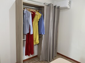 Guests can hang their belongings in the spacious wardrobe, featuring a hanging rod and ample storage.