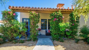 A house with a patio, a door, and a window.