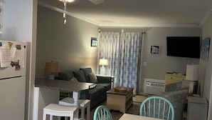 A compact living space with a dining area, kitchenette, and a ceiling fan. - Right on the beach with a GREAT VIEW of the Atlantic Ocean!  Shore Drive, APATB1 (myrtle beach)