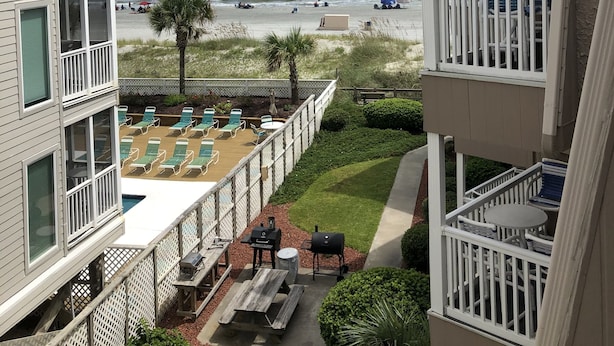 A balcony with a view of the beach, outdoor seating, and a barbecue area. - Right on the beach with a GREAT VIEW of the Atlantic Ocean!  Shore Drive, APATB1 (myrtle beach)
