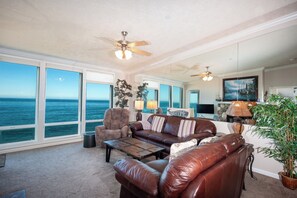 Relax in this ocean-view living area with a sofa, armchair, and coffee table.