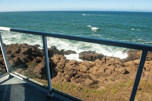 Enjoy breathtaking ocean views from a high vantage point, with waves crashing against the rocky shoreline.