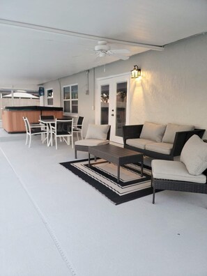 An outdoor patio with a dining table and chairs, a sofa, and a coffee table.