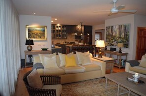 Relax in this inviting living room with a sofa set, coffee table, and dining area.