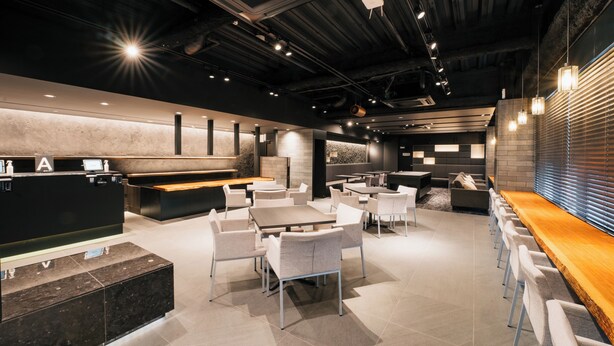 A modern restaurant with a bar area, seating arrangements, and a reception desk. - mizuka Business Canalcity Hakata mae (Fukuoka)