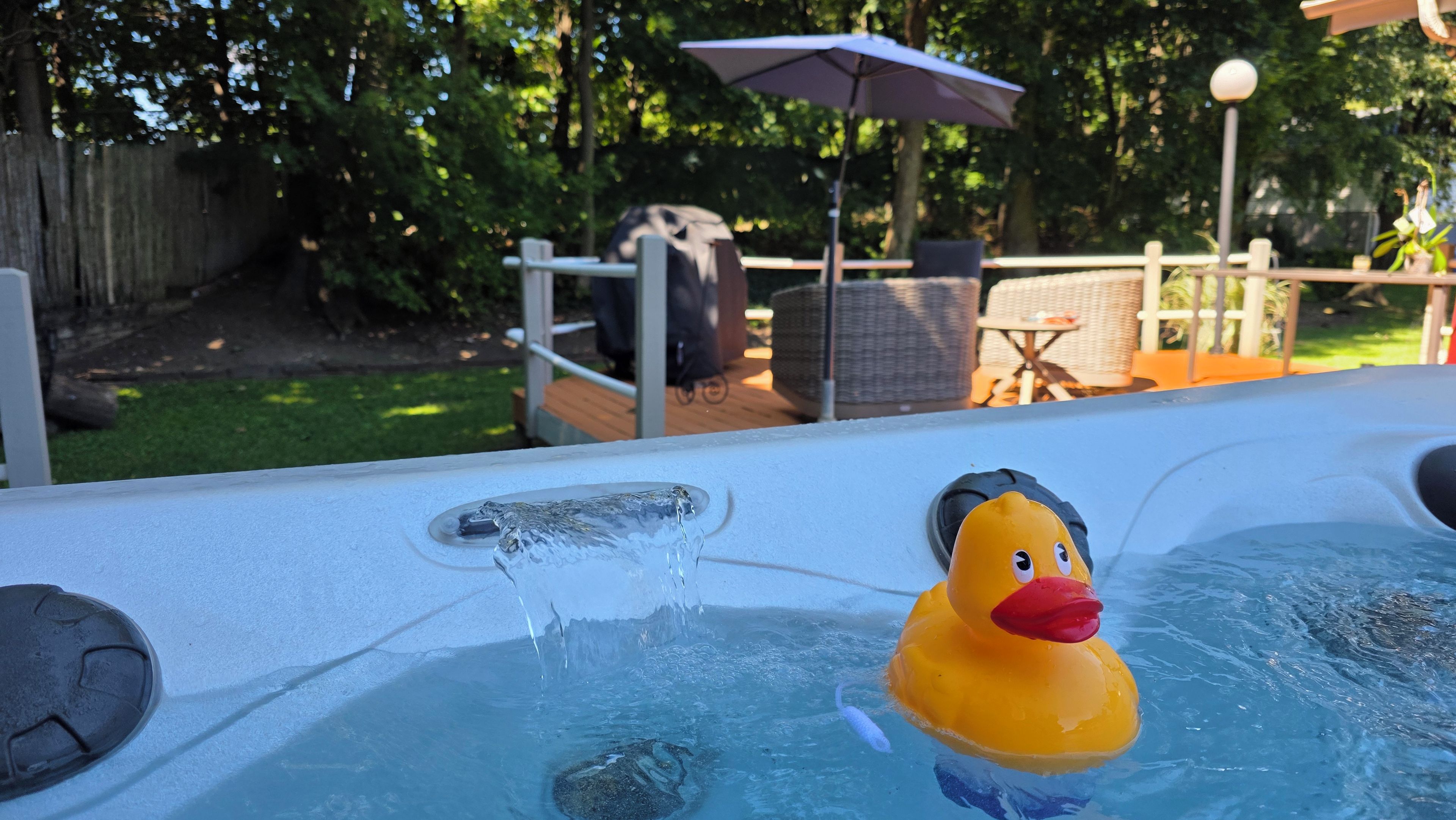 A hot tub with a rubber duck floating in the water.