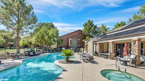 A pool area with lounge chairs and tables, surrounded by buildings and trees. - Safe Privately gated fully furnished 1 bedroom, 1 bath, Condo in prime location!  (Las Vegas)