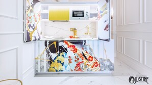 A modern kitchen with a built-in oven, a microwave, and a sink.