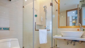 A modern bathroom with a glass-enclosed shower, a white toilet, and a sink with a large mirror above it. - Vienna 3 Best Hotel (Hangzhou)