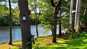 A park with a lake, trees, and a wooden deck. - Waterfront cottage with great view  (parry sound)