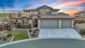 A two-story house with a garage, a stone facade, and a landscaped front yard. - Zion Reunion Poolhouse, PRIVATE POOL, SLEEPS 24! (Washington)