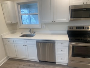 Microwave, dishwasher, coffee/tea maker, cookware/dishes/utensils