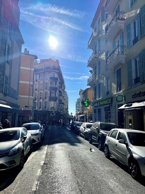 A street with parked cars and buildings.