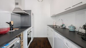 A compact kitchen with a dishwasher, a sink, and a stove. - Stunning apartment in the Gold Square of Nice! (Nice)