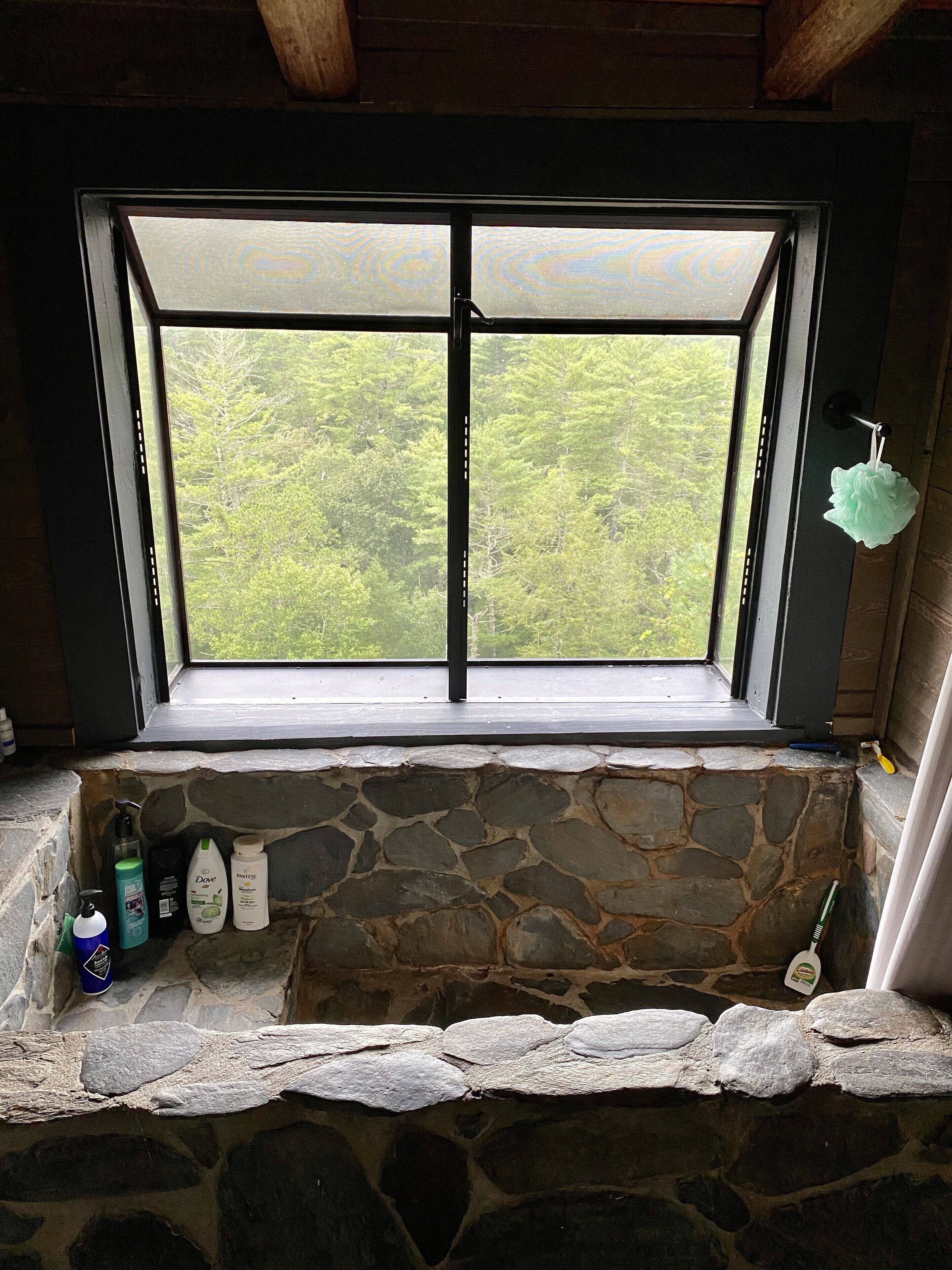A stone ledge with toiletries and a toothbrush.