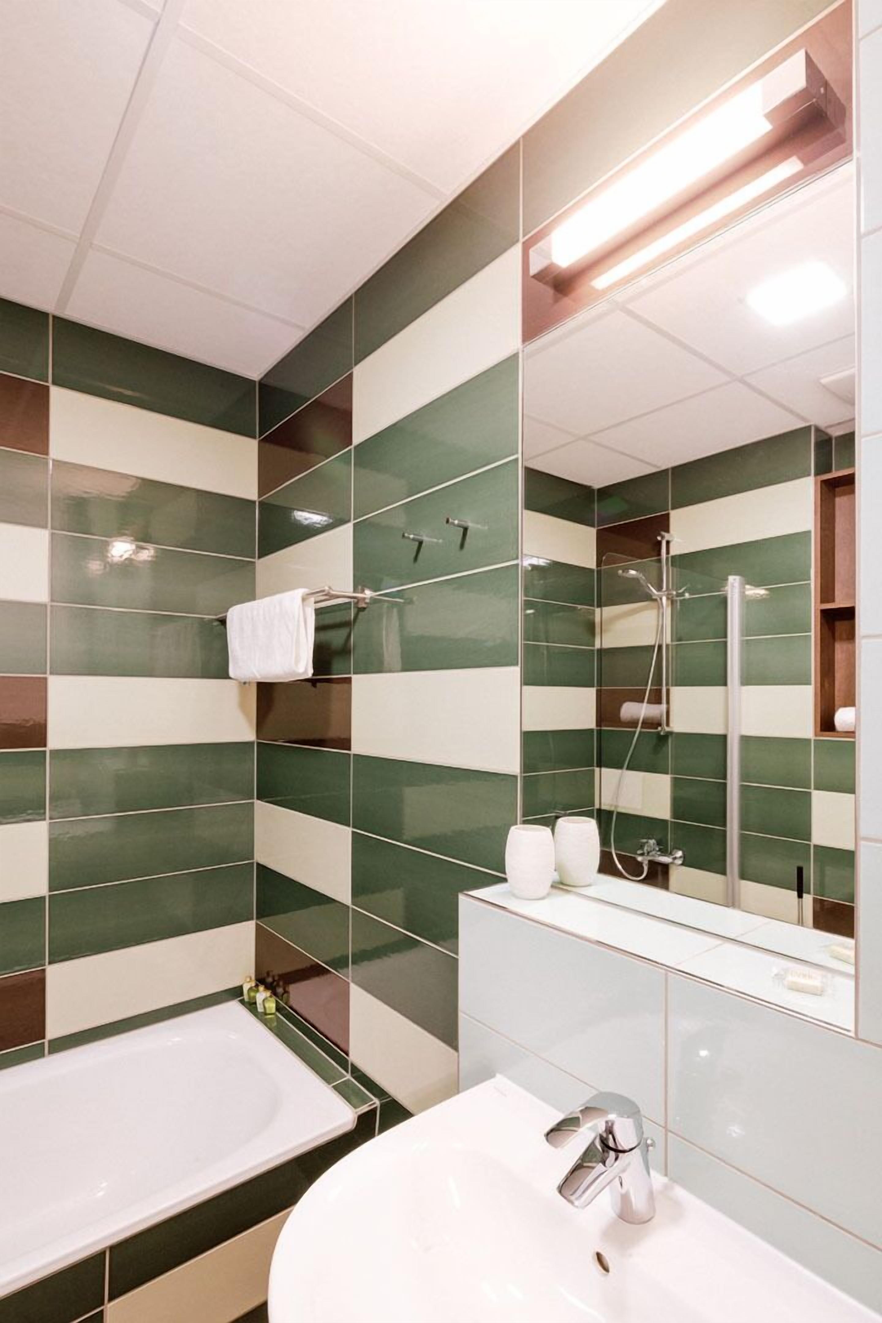 Ein Badezimmer mit Badewanne, Waschbecken und Dusche.