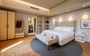 Un dormitorio moderno con una cama grande, un armario, una tocador y una estantería.