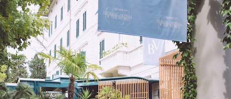 A curved staircase leading to a building with a 'BV' banner.