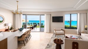 A modern hotel room with a dining area, a living room, and a large balcony with a view of the ocean. - The Residences at The St. Regis Bermuda (Town of St. George)