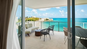 A balcony with a view of the ocean, a table, chairs, and a sofa. - The Residences at The St. Regis Bermuda (Town of St. George)