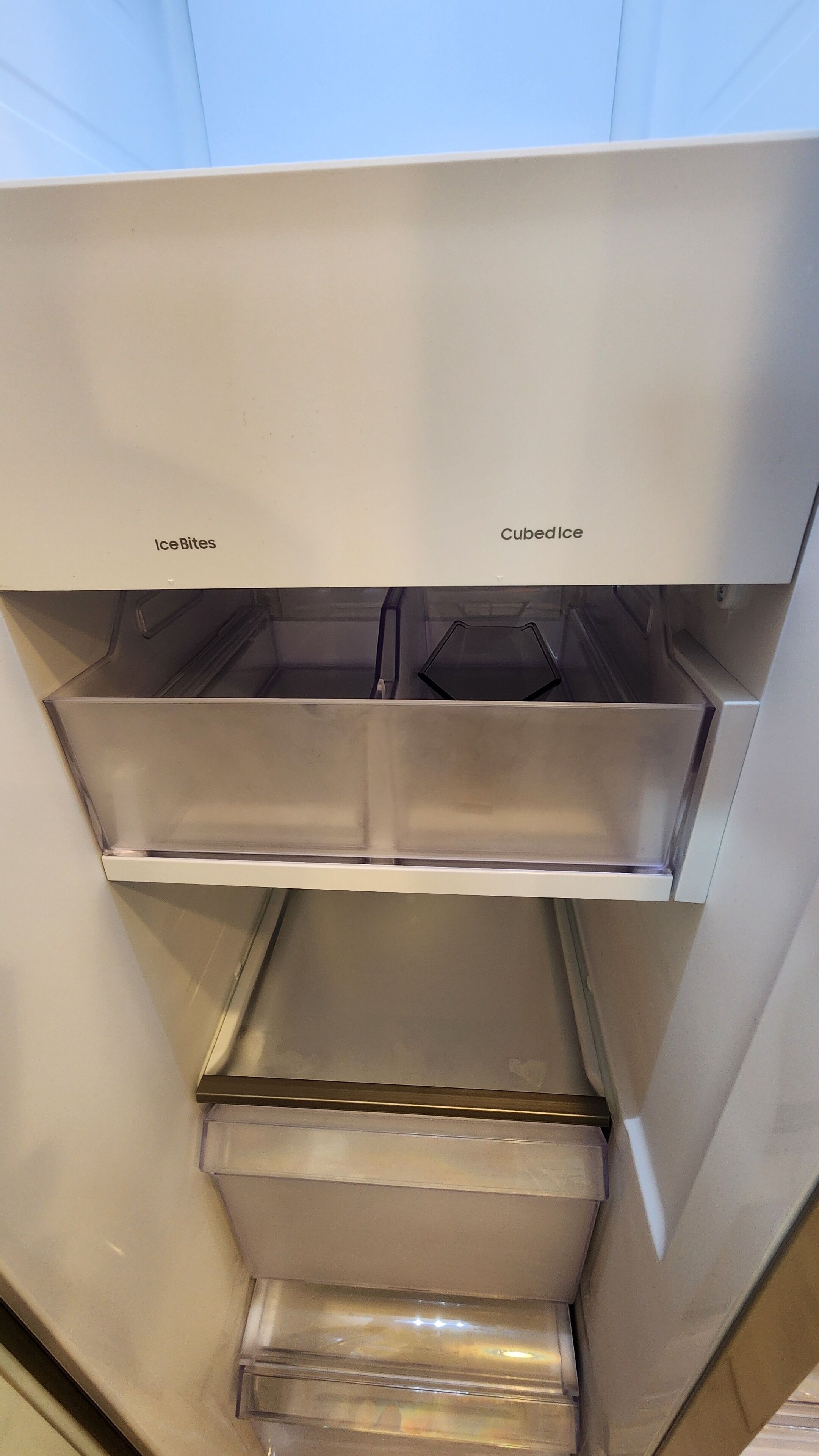 A kitchen with a stainless steel refrigerator, a microwave, and a built-in oven.