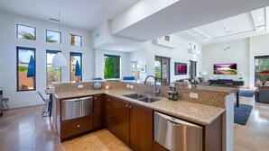 A modern kitchen with granite countertops, stainless steel appliances, and a large island. - Luxury Modern Oasis w/ Salt Pool, Spa & Zen Yard (Rancho Mirage)