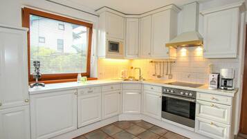 Microwave, oven, dishwasher, dining tables