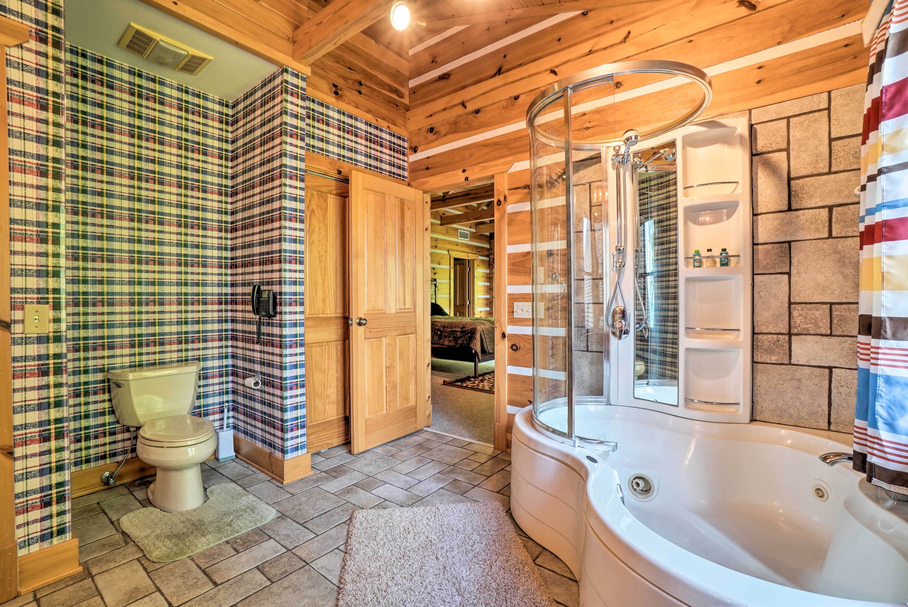 A bathroom with a toilet, a shower, and a bathtub.